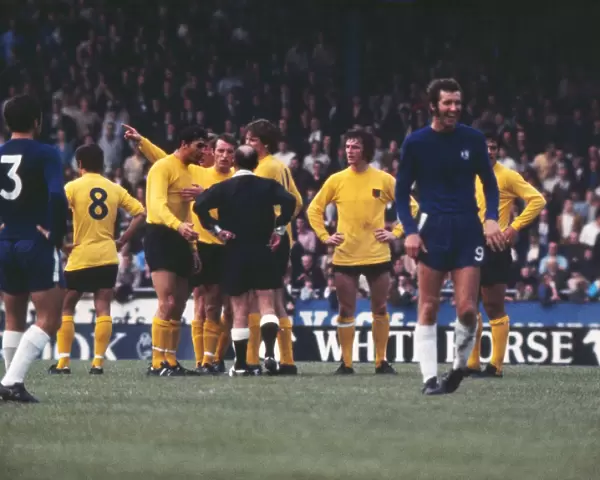 Peter Osgood laughs as Ipswich players appeal to the referee