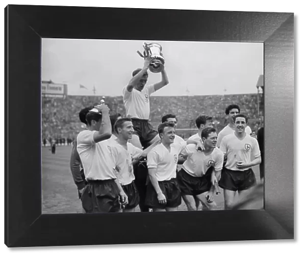 Danny Blanchflower celebrates with his teammates after Tottenham win the FA Cup in 1961
