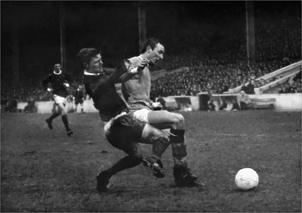 Bobby Noble and Mike Summerbee compete for the ball in the 1966  /  7 Manchester derby at Maine Road