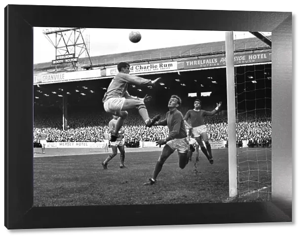 Mike Doyle jumps for a header in the 1967  /  8 Manchester derby at Maine Road