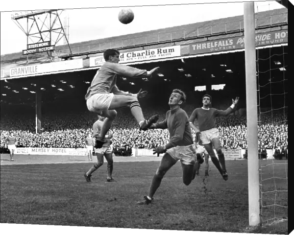 Mike Doyle jumps for a header in the 1967  /  8 Manchester derby at Maine Road