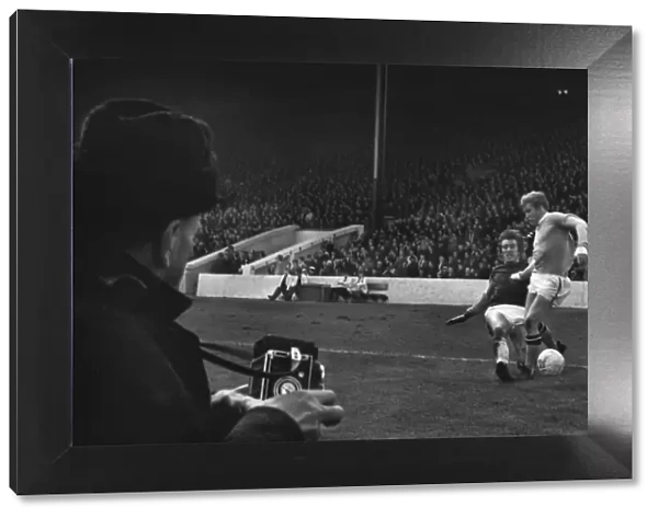 West Hams Billy Bonds tackles Manchester Citys Tony Coleman as a photographer looks on