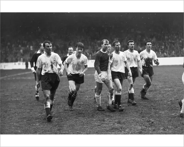 A dejected Bobby Charlton walks off the field with the Spurs players after the 1962 FA Cup semi-final