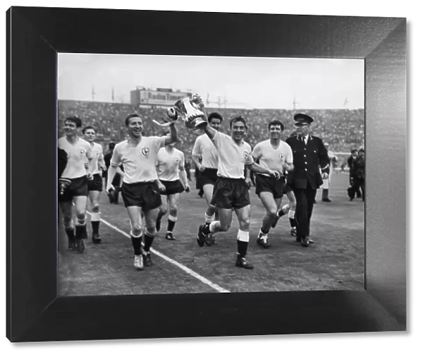Cliff Jones and Jimmy Greaves parade the FA Cup around Wembley after Spurs victory in 1962