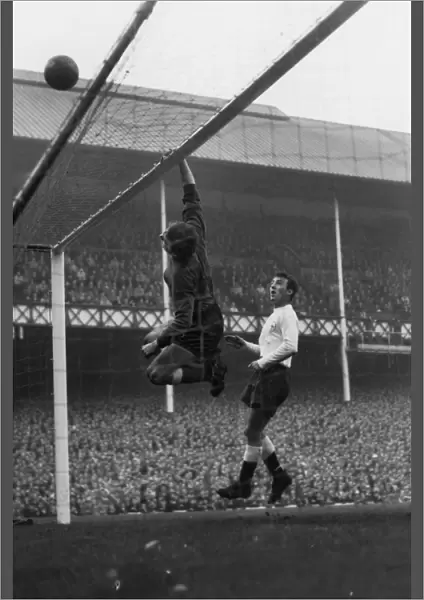 Everton goalkeeper Gordon West tips over a shot as Spurs Jimmy Greaves looks on at Goodison Park