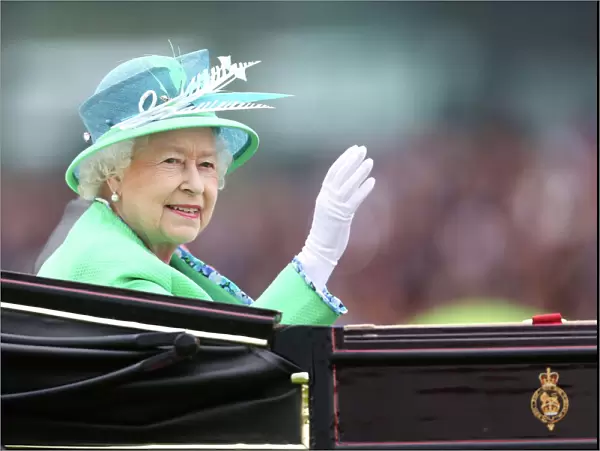The Queen waves to the crowd at Royal Ascot
