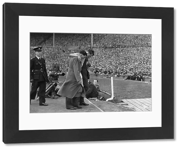 Manchester Citys Jimmy Meadows leaves the field with a knee injury in the 1955 FA Cup Final