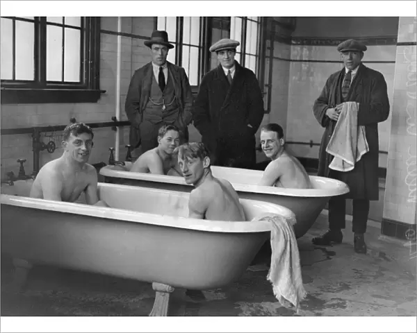 Aston Villa bathe in the changing rooms baths after a training session in 1923  /  4