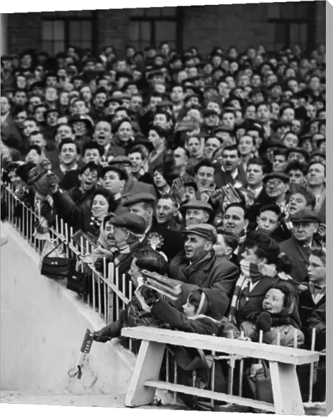 Manchester United fans cheer their team onto the field before the 1958 FA Cup semi-final