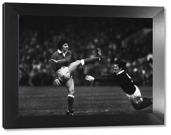 Wales Gareth Davies kicks under pressure from Alan Lawson - 1979 Five Nations