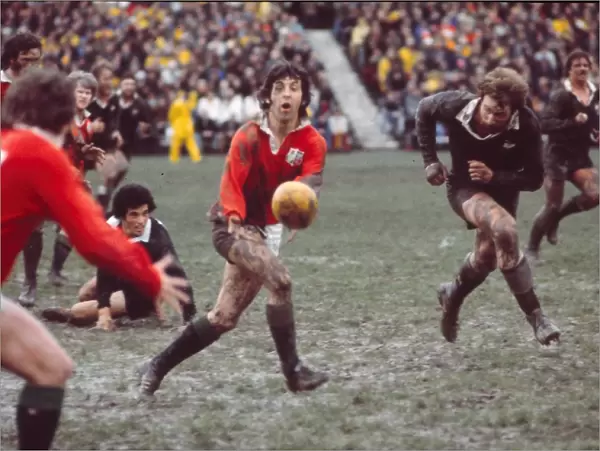 Ian McGeechan passes for the Lions at a muddy Athletic Park - 1977 British Lions Tour to New Zealand