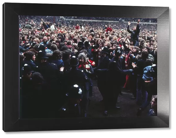 Manchester United fans invade the pitch after Bobby Charltons final home game for the club
