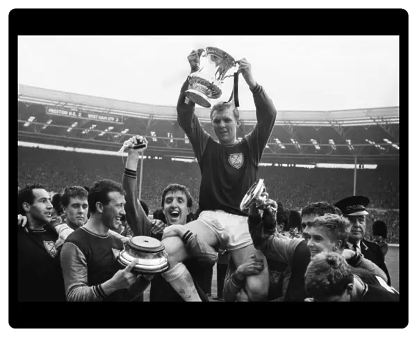 West Ham United captain Bobby Moore is chaired on his teammates shoulders after victory in the 1964 FA Cup