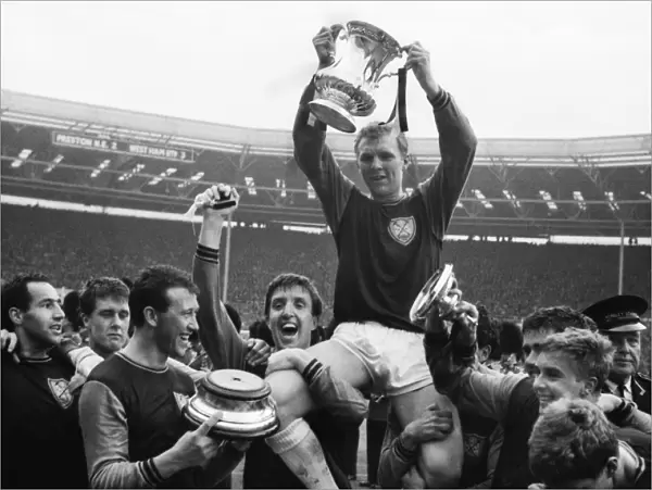West Ham United captain Bobby Moore is chaired on his teammates shoulders after victory in the 1964 FA Cup