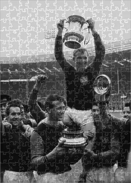 West Ham captain Bobby Moore lifts the FA Cup trophy in 1964