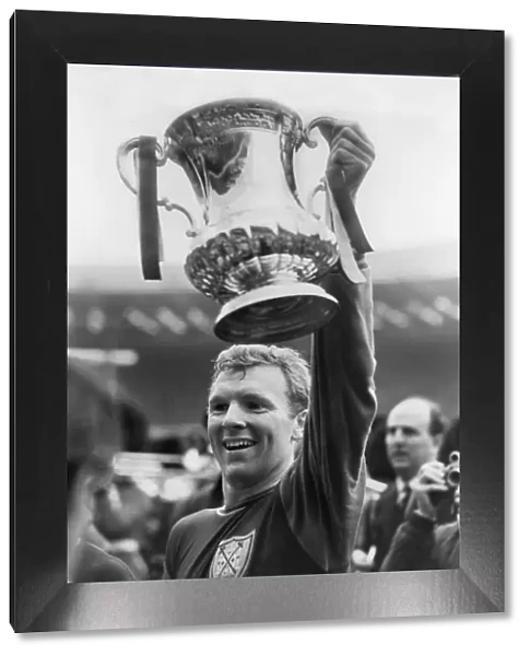 West Ham captain Bobby Moore lifts the FA Cup in 1964