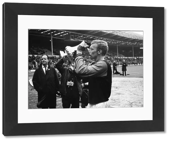 West Ham captain Bobby Moore drinks out of the FA Cup after victory in 1964