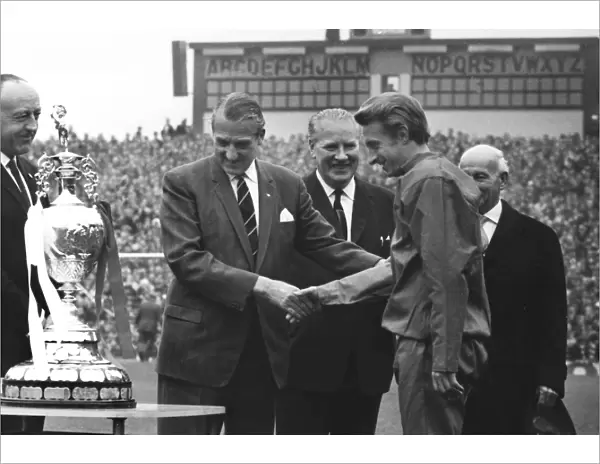League President Len Shipman presents the Championship trophy to Manchester United co-captain Denis Law in 1967