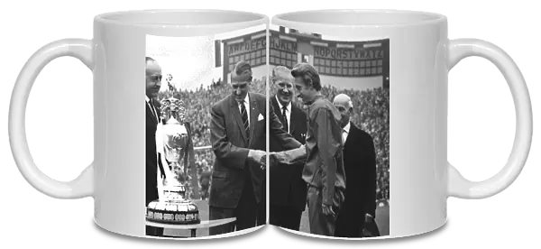 League President Len Shipman presents the Championship trophy to Manchester United co-captain Denis Law in 1967
