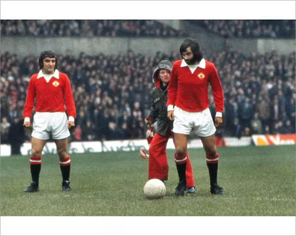 George Best is greeted by a young fan at he attempts to kick-off for Manchester United