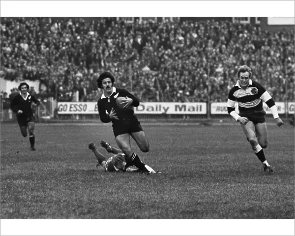 Bryan Williams makes a break for the All Blacks against the Barbarians in 1973