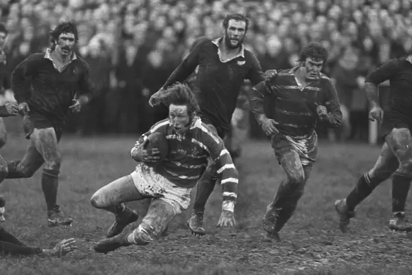 A bloodied JPR Williams in action for Bridgend against the All Blacks in 1978