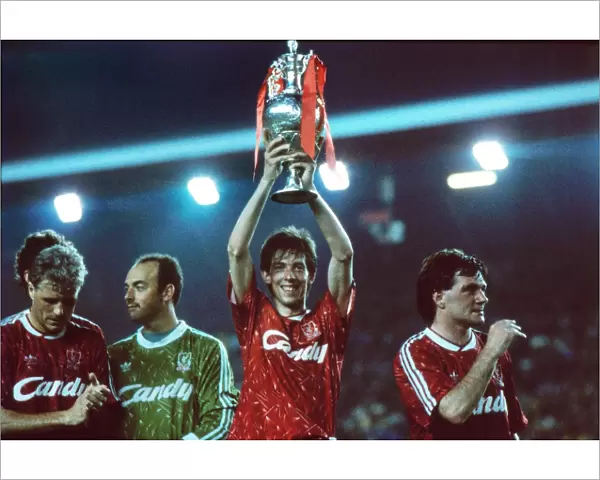 Liverpools Gary Ablett holds the League Championship trophy afloft in 1990