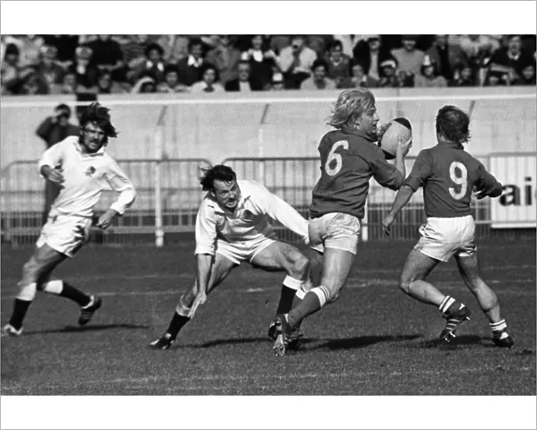 Englands Andy Maxwell tackles Frances Jean-Pierre Rives - 1976 Five Nations