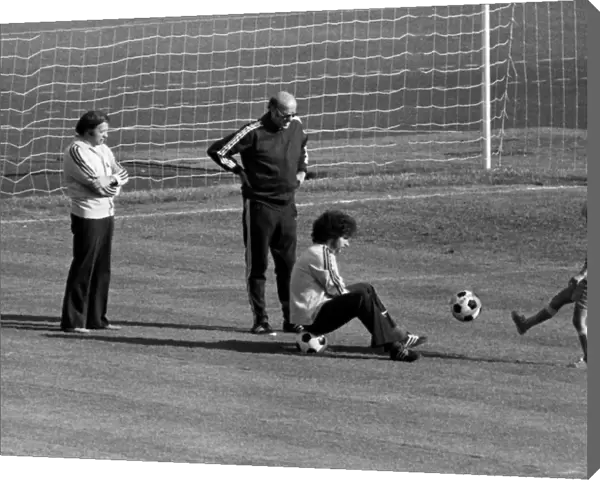 Paul Breitner sits on a ball with Helmut Schoen after West Germany training - 1974 World Cup