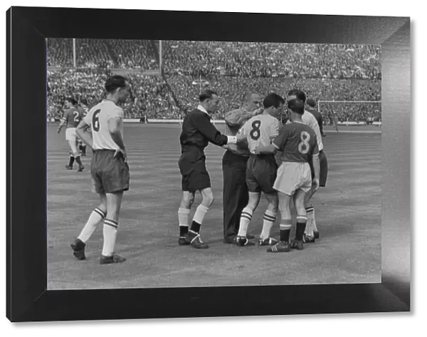 Boltons Dennis Stevens is helped to his feet after lying injured - 1958 FA Cup Final