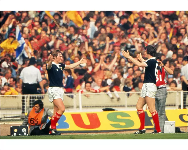 Kenny Dalglish celebrates his goal with Bruce Rioch in front of the Scotland fans at Wembley - 1977 British Home Championship