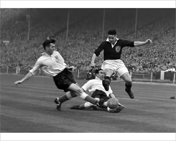 Englands Malcolm Barrass slides in to tackle Billy Liddell - 1952  /  3 British Home Championship