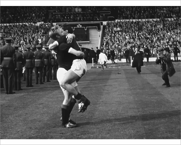 Scotlands Davie Wilson hugs a teammate after victory at Wembley - 1962  /  3 British Home Championship