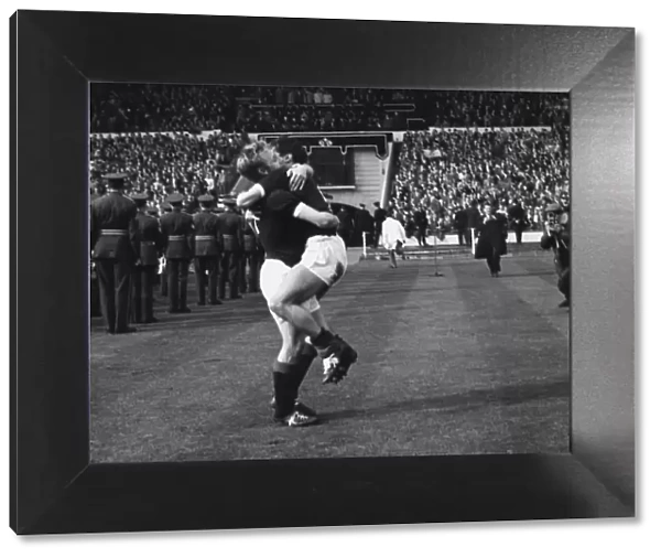 Scotlands Davie Wilson hugs a teammate after victory at Wembley - 1962  /  3 British Home Championship