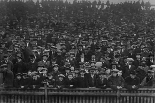 Fans in flat caps in the stands at St Andrews in 1922