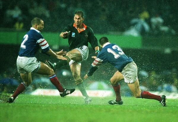 Andre Joubert kicks ahead in the rain during the 1995 Rugby World Cup semi-final