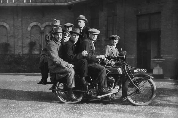 Aston Villa players on the back of Cyril Spiers motor cycle in the grounds of Villa Park in 1923 / 4