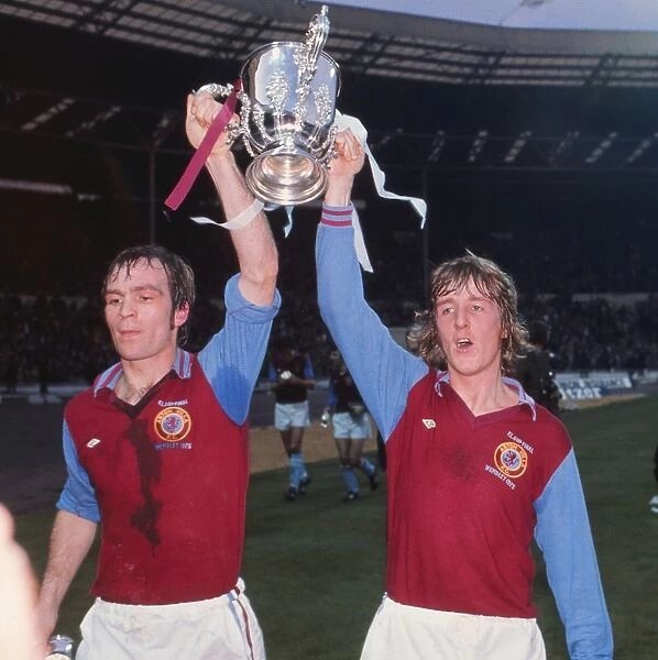 Aston Villas Ian Ross and Ian Chico Hamilton parade the League Cup in 1975