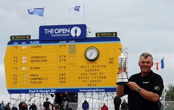 Darren Clarke - the 2011 Open Champion in front of the final scoreboard