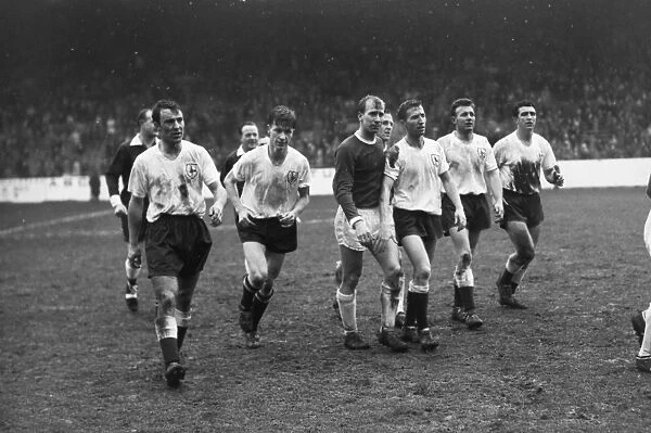 A dejected Bobby Charlton walks off the field with the Spurs players after the 1962 FA Cup semi-final