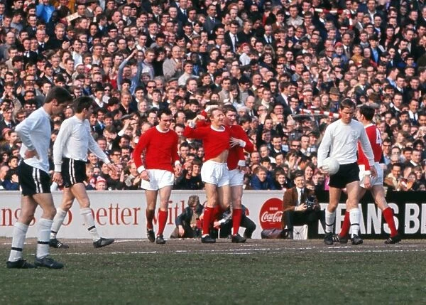 Denis Law celebrates scoring for Manchester United in 1967 / 8