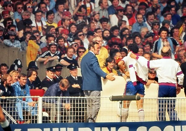 England manager Don Revie comes off the bench to meet Ray Kennedy after his substitution against Scotland- 1977 British Home Championship