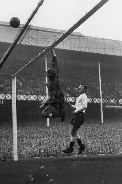 Everton goalkeeper Gordon West tips over a shot as Spurs Jimmy Greaves looks on at Goodison Park