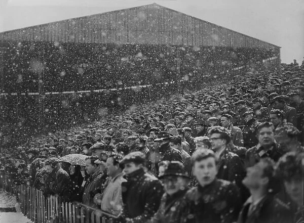 Fans at Old Trafford watch the action in the snow during the 1954 / 5 FA Cup