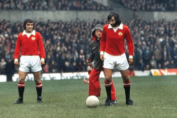 George Best is greeted by a young fan at he attempts to kick-off for Manchester United