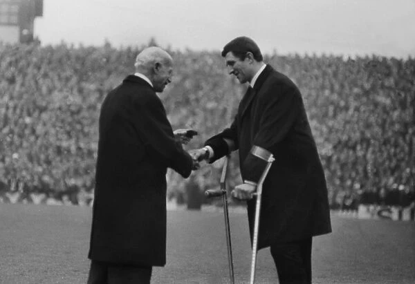 Injured Manchester United striker David Herd receives his League Championship winners medal in 1967