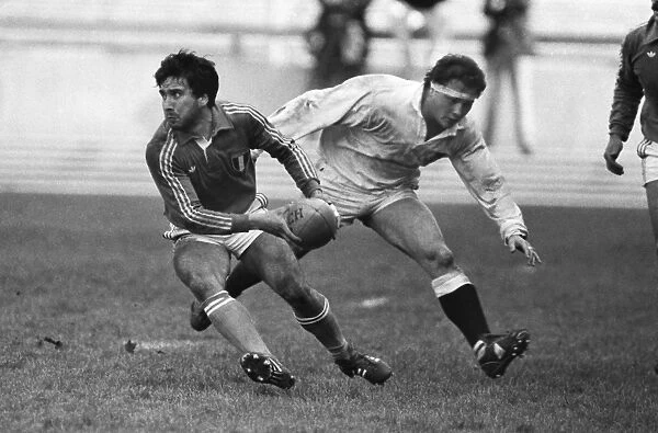 Italys Alessandro Ghini under pressure from Brian Moore of England B in 1985