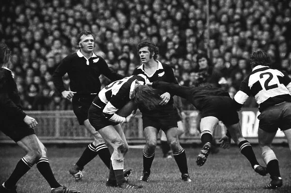 JPR Williams is high-tackled for the Barbarians against the All Blacks in 1973