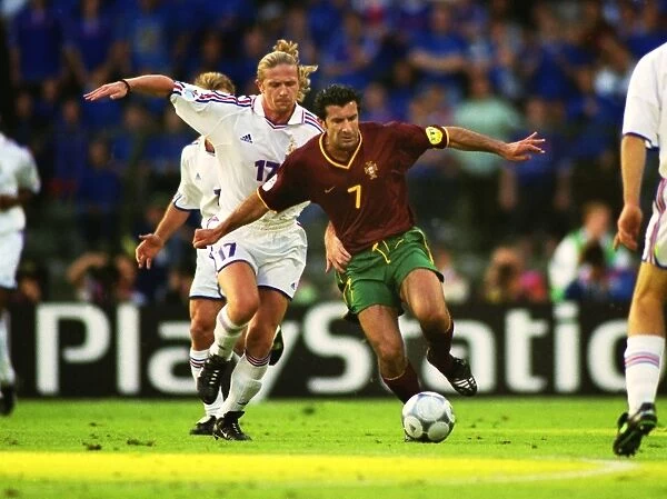 Luis Figo under pressure from Emmanuel Petit during the semi-final of Euro 2000