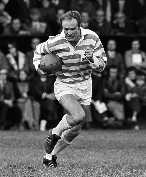 Mike Gibson runs with the ball for a Cambridge University Past and Present side in 1972